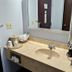 Briarwood Inn in Sparta bathroom vanity with sink, mirror, coffee maker and wall-mounted hair dryer