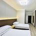 Harbin Dream Family Apartment in Harbin: simple twin-bed guest room with wood flooring and bright ceiling light