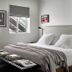 Bluebird Spa City Motor Lodge in Saratoga Springs guest room with king bed, desk, and two windows
