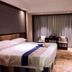 Zhangzhou Yinjia Hotel (Gucheng Branch) guest room with large bed, seating area, and window curtains in Zhangzhou