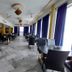 Hotel Sea Coast in Digha dining area with tables, chairs, marble floor, and large windows with blue curtains