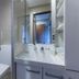 Kumano No Yado Umihikari bathroom with toilet, sink, mirror and glass shower enclosure in Kumano