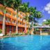 Rainbow Ruiru Resort in Nairobi with palm-lined outdoor pool, poolside bar, and orange hotel building