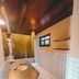 Pousada Fortal Jeri bathroom in Jijoca de Jericoacoara with tiled shower, sink, and wood ceiling