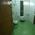 Misty Green Homestay, Thekkady: compact bathroom with shower, toilet, sink and green floor tiles
