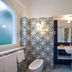 Palazzo Marzoli Resort in Positano bathroom with patterned tile, soaking tub, and frosted window