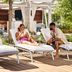 Guests relaxing on lounge chairs by the pool at Loews Arlington Hotel in Arlington