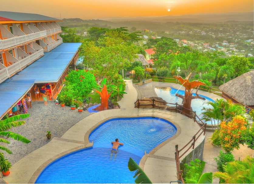 Cahal Pech Village Resort in San Ignacio with hilltop pool, lush gardens and sunset valley views