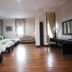 Campago Resort Hotel in Bukittinggi guest room with three single beds, desk, TV, and wooden floor
