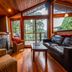 The Cabins at Terrace Beach in Ucluelet cabin living room with forest-view windows and fireplace