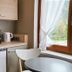 Hotel Kachelburg in Dieblich kitchenette with microwave, mini fridge, kettle and a window view