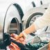 Comfort Hotel Tomakomai laundry room with person loading clothes into a front-load washer