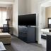 Residence Inn by Marriott Dayton Vandalia room with sofa, desk, TV, and adjacent bedroom doorway in Dayton