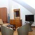 Elite Hotel in Port Au Prince guest room with seating area, dresser, TV and sloped ceiling