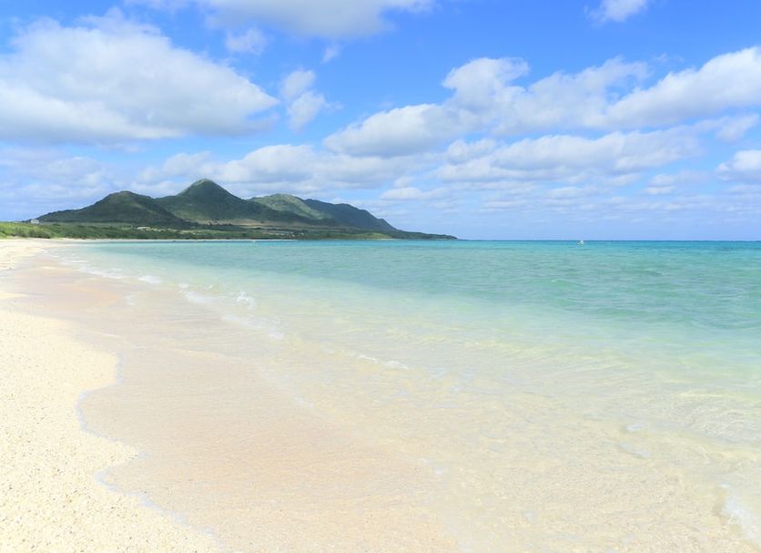 Nata Beach Villa in Ishigaki with white-sand beach, turquoise sea, and distant green mountains