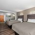 Quality Inn & Suites Biloxi - Ocean Springs guest room with two beds and wood-look flooring