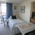 Windjammer By The Sea Hampton guest room with twin beds and balcony view