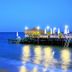 Ulusoy Kemer Holiday Club - Kids Concept in Göynük with a lit pier over the sea at dusk