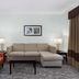 La Quinta Inn & Suites by Wyndham Bonita Springs Naples N. suite with sofa, chair and coffee table