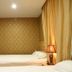 Center Of City Creo Hotel in Yanbian guest room with twin beds, wall-mounted TV, and warm lighting