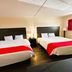 Oyo Hotel San Antonio Lackland AFB/Seaworld Hwy 90 W room with two double beds and red accents