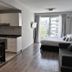 CH Recoleta Suites Buenos Aires studio with kitchenette, sofa, and balcony view