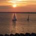 The Woodvale, Cowes: sailboats on the water at sunset with a glowing horizon