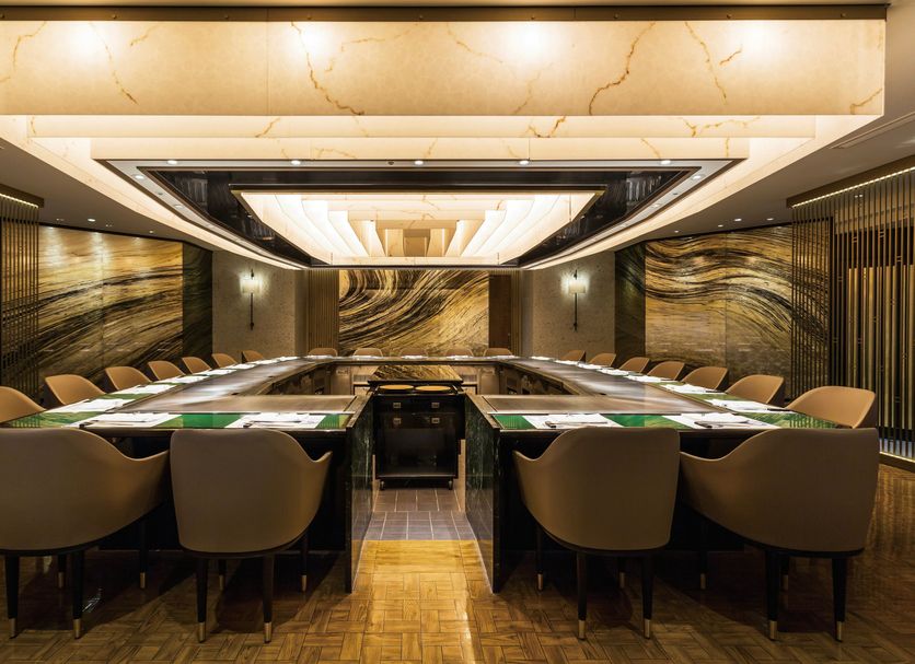 Imperial Hotel Tokyo meeting room in Tokyo with a long conference table and tan chairs
