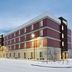 Home2 Suites by Hilton Anchorage/Midtown exterior in Anchorage, snow-covered lot at dusk