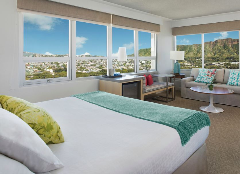 Queen Kapiolani Hotel Honolulu room with Waikiki and Diamond Head views, bed and sitting area