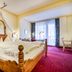 Hotel & Restaurant Wastlwirt in Sankt Michael Im Lungau features a canopy wooden bed and balcony view