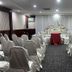 Hotel Seri Malaysia Genting Highlands meeting room set with rows of white chair covers and a decorated table