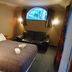 Kiwi's Nest Budget Accommodation & Backpackers room in Dunedin with double bed, sofa and window seat
