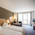 First Mountain Montafon in Gaschurn: twin bed guest room with balcony doors and mountain-view window.