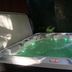 The Macaw Guesthouse in New York with an indoor hot tub and green underwater lights