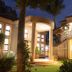 Zawadi House, Arusha hotel exterior at night with lit entrance, palm trees and landscaped garden