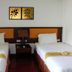 OYO 389 Sira Boutique Residence in Patong, twin beds with white linens and orange headboards