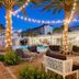 Hotel Cabana Clearwater Beach in Clearwater Beach, lit palm-lined pool courtyard with hanging lounge chairs