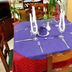 Islazul Isla De Cuba in Camagüey, set dining table with purple cloth and red chair covers