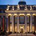 The Wellem in Düsseldorf, illuminated grand hotel facade with tall columns and steps at dusk