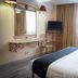 Hotel Santa Maria, Mexico City guest room with double bed, TV, mirror and window curtains