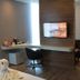 Luminor Hotel Jemursari by Wh, Surabaya guest room with desk, TV, chair and swan towel art
