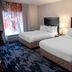 Fairfield Inn & Suites by Marriott Lewisburg room with two beds, window and bedside lamp