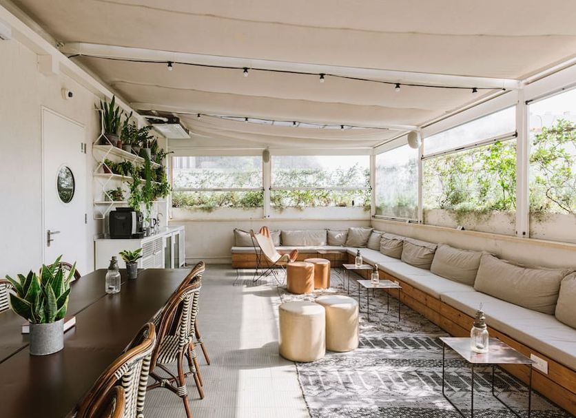 Hotel Saul in Tel Aviv rooftop lounge with long sectional seating and greenery