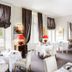 Dining room at Domaine et Golf de Vaugouard - La Maison Younan in Fontenay-sur-Loing with set tables and red lamps.