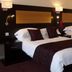 The Woodvale, Cowes: twin hotel room with two beds, wall lamps, and burgundy bedding