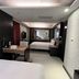 Guide Hotel Taipei Xinyi guest room with two beds, desk, and wall mirror in Taipei City