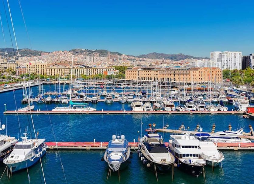H10 Port Vell in Barcelona with marina yachts, waterfront promenade and city skyline