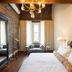 Hotel Cleo, Knoxville Downtown, a Tribute Portfolio Hotel guest room with brick walls and chandelier