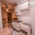 Pampulha Flat Belo Horizonte kitchenette with stove, countertop, cabinets and small dining area